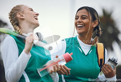 Image of Funny, team sports or women in conversation on turf or court for break after fitness training or exercise. Smile, happy friends or female hockey players walking, laughing or talking to relax together