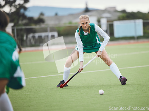 Image of Field, hockey and woman in sports, game or action in competition with ball, stick and team on artificial grass. Sport, teamwork and women play in training, exercise or workout for goals in match