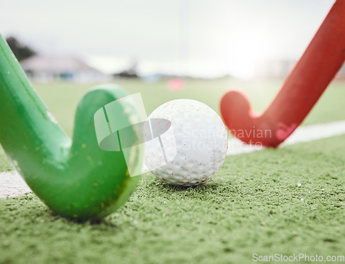 Image of Hockey, game and stick with ball on green, field or pitch with sports equipment in competition, match ground or floor. Artificial grass, turf or training with gear in sport, tournament or stadium