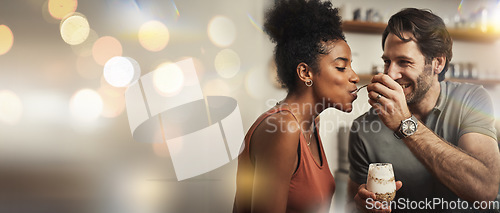 Image of Love, dessert and feeding with a couple on space in their home together for romance or dating. Smile, mockup or banner with an interracial man and woman eating in the kitchen on their anniversary