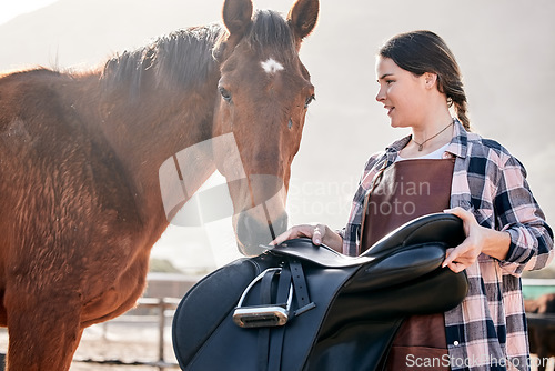 Image of Horse, rider and woman with saddle on ranch for animal care, training and riding on farm. Agriculture, countryside and person with equipment for stallion for practice, freedom and adventure outdoors