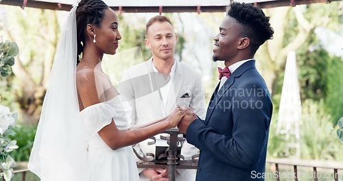 Image of Happy black couple, wedding and vows in marriage, commitment or support together at alter. Married African woman and man holding hands for love, trust or speech of bride or groom in outdoor romance