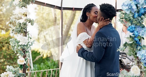 Image of Happy black couple, wedding and kiss for love, marriage or commitment in support together. Married African woman and man kissing in embrace, trust or relationship of bride or groom in outdoor romance