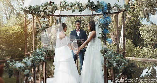 Image of Women, lesbian wedding and ceremony outdoor with priest for love, celebration or together for commitment. Gay marriage, event and party with bride, black man or vows in nature, lgbtq couple or garden