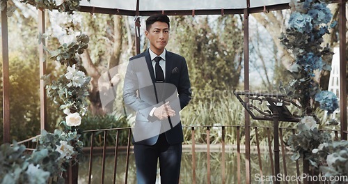 Image of Groom, waiting and man in wedding or ceremony at alter with anxiety, stress or nervous energy for marriage or commitment. Formal, suit and excited person standing in aisle with flowers and nature