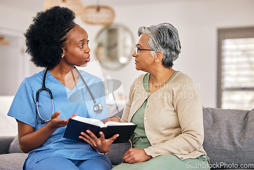 Image of Bible, religion and assisted living caregiver with an old woman in a retirement home together. Healthcare, christian faith or belief with a nurse or volunteer reading to a senior patient in a house
