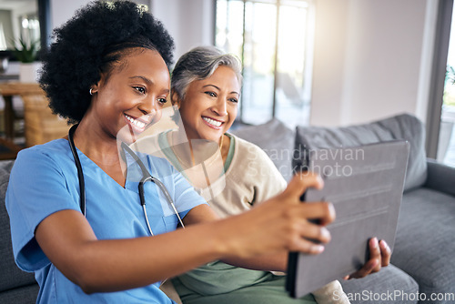 Image of Selfie, tablet and assisted living caregiver with an old woman in the living room of a home together. Smile, support or community with a happy nurse or volunteer and senior patient in a house