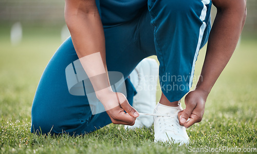 Image of Person, tie and shoes on grass in fitness or getting ready for sports workout, training or outdoor exercise. Closeup of athlete tying shoe on field in preparation for running or practice in nature