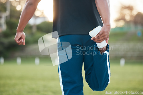 Image of Person, fitness and stretching leg on grass getting ready for sports training, workout or outdoor exercise. Rear view of sporty athlete in warm up for preparation, motivation or health and wellness
