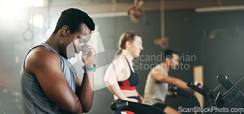 Image of People, diversity and cycling on bicycle at gym in workout, exercise or intense cardio fitness together and motivation. Diverse group burning sweat on machine in healthy body, wellness or lose weight