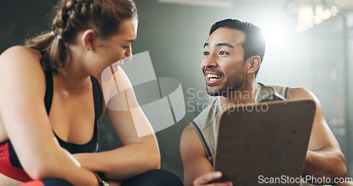 Image of Man, woman and clipboard with talking in gym, sign up and planning for ideas, workout and smile with info. Personal trainer, paperwork and client for fitness, checklist and recruitment for wellness