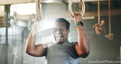 Image of Gym, intense gymnastics and black man doing pull up exercise, arm muscle building or bodybuilding for strength training. Determined, athlete and African person doing fitness, challenge or workout