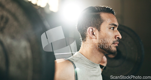 Image of Man at gym, weight lifting and barbell for muscle building endurance, strong body and balance power in fitness. Commitment, motivation and bodybuilder in workout challenge for health and wellness.