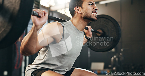 Image of Man at gym, weight lifting and barbell with focus on muscle building endurance, strong body and balance power in fitness. Commitment, motivation and bodybuilder in workout for health and wellness.