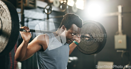 Image of Black man at gym, weight lifting and barbell for muscle building endurance, strong body or balance power in fitness. Commitment, motivation and bodybuilder in workout challenge in health and wellness