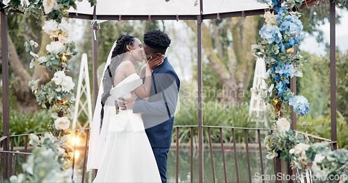 Image of Wedding, dance and kiss, black couple in garden with love, celebration and excited for future together. Gazebo, man and woman at marriage reception with flowers, music and happiness at outdoor party