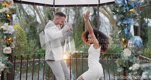 Image of Dance, happy and a couple at a wedding with love, bonding and fun in marriage. Smile, excited and a young man and woman with celebration, moving and energy together after commitment in relationship