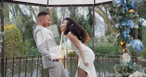 Image of Wedding, fun dance and happy couple in garden with love, celebration and excited for future together. Gazebo, man and woman at marriage reception with flowers, music and happiness at party in nature.
