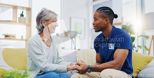 Image of Black man, caregiver or old woman holding hands for support consoling or empathy in therapy. Medical healthcare advice, senior person or male nurse nursing, talking or helping elderly patient.