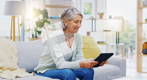 Image of Relax, tablet and senior woman on sofa in living room scroll on social media, mobile app or the internet. Rest, online and elderly female person browsing on website with technology in lounge at home.