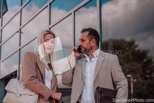 Image of Modern business couple after a long day's work, walking together towards the comfort of their home, embodying the perfect blend of professional success and personal contentment.