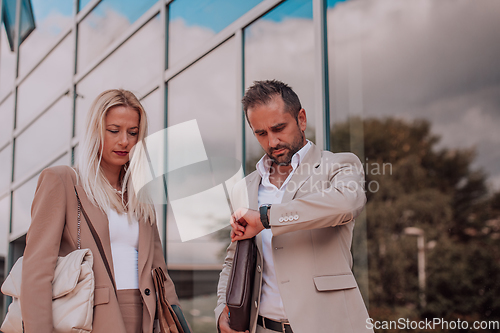 Image of Modern business couple after a long day's work, walking together towards the comfort of their home, embodying the perfect blend of professional success and personal contentment.