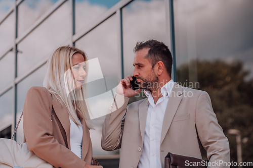 Image of Modern business couple after a long day's work, walking together towards the comfort of their home, embodying the perfect blend of professional success and personal contentment.