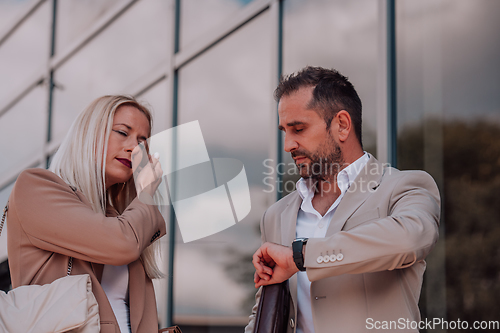 Image of Modern business couple after a long day's work, walking together towards the comfort of their home, embodying the perfect blend of professional success and personal contentment.