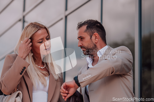 Image of Modern business couple after a long day's work, walking together towards the comfort of their home, embodying the perfect blend of professional success and personal contentment.