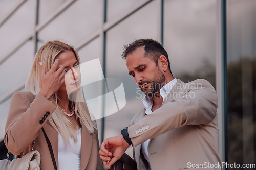 Image of Modern business couple after a long day's work, walking together towards the comfort of their home, embodying the perfect blend of professional success and personal contentment.