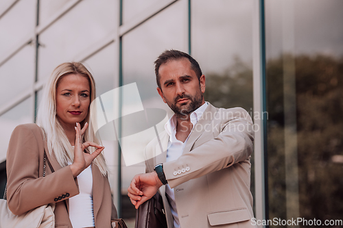 Image of Modern business couple after a long day's work, walking together towards the comfort of their home, embodying the perfect blend of professional success and personal contentment.