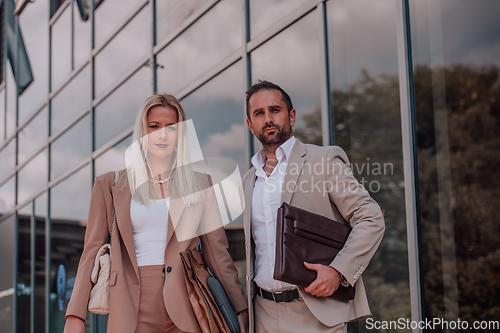 Image of Modern business couple after a long day's work, walking together towards the comfort of their home, embodying the perfect blend of professional success and personal contentment.