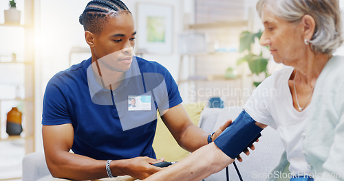 Image of Caregiver, black man or old woman with blood pressure test consulting in hospital to monitor heart wellness. Healthcare, hypertension consultation or medical nurse with sick patient for examination