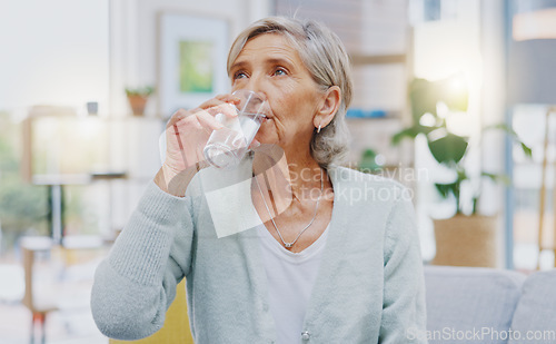 Image of Wellness, home or healthy old woman drinking water for healthcare or natural vitamins in a house. Retirement, elderly relaxing or thirsty senior person refreshing with liquid for energy or hydration