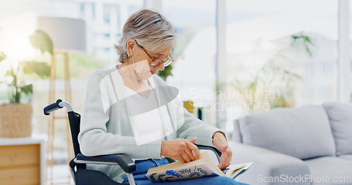 Image of Senior woman, book and reading to relax in living room for story, novel and knowledge. Elderly female in wheelchair, enjoying books and focus in lounge for retirement break, literature and hobby at r