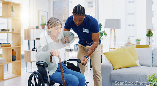 Image of Help, home care and a woman with a caregiver and a wheelchair for disability, support and consulting. Happy, talking and a black man or male nurse helping a senior patient into a chair for nursing