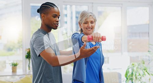 Image of Elderly woman, dumbbells and rehabilitation therapist for exercise in a nursing home. Happy senior patient with physiotherapist man or nurse for healing, health and physiotherapy for muscle and body