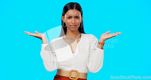 Image of Comparison, thinking and what hands of woman portrait with choice in a studio with question or idea emoji gesture. Decision, doubt and female person with option, balance or shrug and blue background
