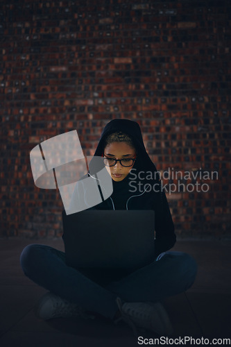 Image of Hacker, woman in basement and laptop, information technology for coding and database with phishing and cyber crime. Cybersecurity, programming or hacking, criminal with pc for ransomware and firewall