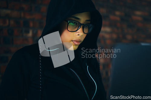 Image of Hacker, woman in dark room with laptop and information technology, coding and database, phishing with cyber crime. Cybersecurity, programming or hacking, criminal with pc for ransomware and firewall