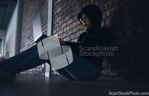 Image of Hacker, woman in dark room with laptop and information technology, phishing and cyber crime with database or server. Cybersecurity, programming and criminal with pc, ransomware and firewall breach