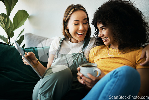 Image of Couple, sofa and women relax with tablet and coffee for social media, internet and watching videos. Love, lgbtq and happy people in living room for bonding, relationship and streaming movies online