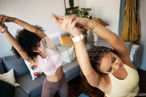 Image of Yoga, stretching and girl friends in the living room doing a warm up exercise together for wellness. Calm, peace and young women doing pilates workout for breathing in the lounge at modern apartment.