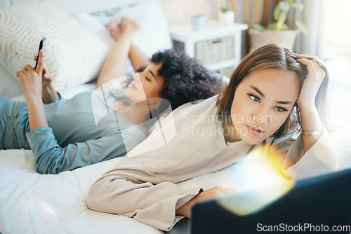 Image of Laptop, social media and morning with a lesbian couple in bed together in their home on the weekend. Diversity, computer and an lgbt woman browsing with her girlfriend in the bedroom for love