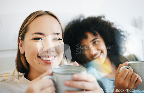 Image of Coffee, smile and portrait of lesbian couple on bed in conversation for bond and relax together. Happy, rest and interracial lgbtq women laughing, talking and drinking latte in bedroom of apartment.