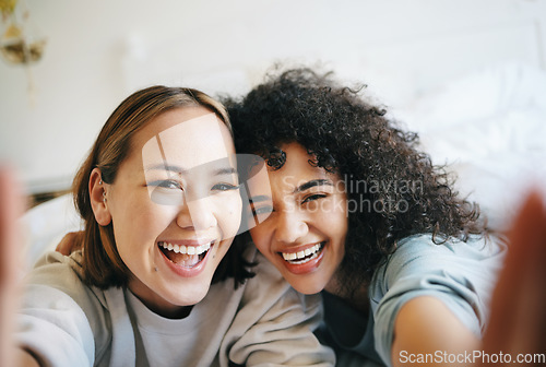 Image of Love, selfie and portrait of lesbian couple on bed for bonding, resting or relaxing together. Smile, happy and young interracial lgbtq women taking a picture in bedroom of modern apartment or home.