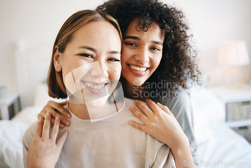 Image of Smile, happy and portrait of lesbian couple on bed for bonding, resting or relaxing together on weekend. Love, romance and young interracial lgbtq women in the bedroom of modern apartment or home.