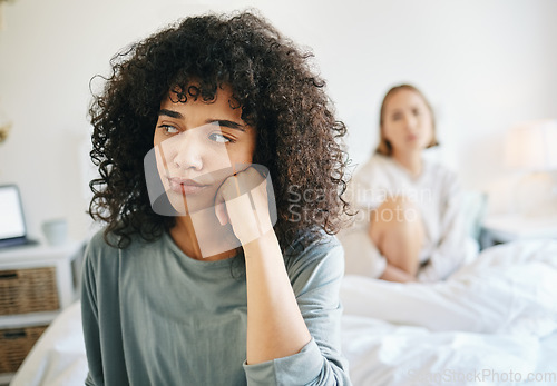 Image of Lgbtq, woman and frustrated for couple fight in bedroom of home with conflict, crisis or problem in relationship. Lesbian, partner and girl on bed with stress, anxiety and depressed for argument