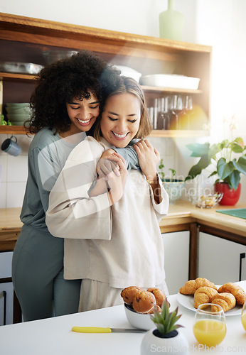 Image of Breakfast, lgbtq and couple hug in morning in home eating together for bonding, love and care. Embrace, lesbian and happy women with food for healthy relationship, nutrition and meal for romance