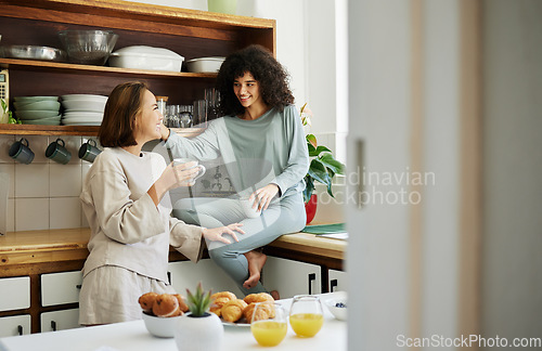 Image of Lgbtq, women and couple with love in kitchen for breakfast, nutrition and vitamin c in the morning. Food, people and happiness with coffee and pajamas or natural face for wellness, romance and care